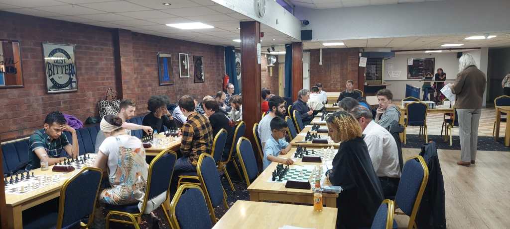 Battersea Grand Prix (Summer Knights), July 2023. A diverse group playing chess. Djuna Tree (organiser) shown on far right.